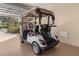 White Yamaha golf cart in the garage, rear view at 7290 Se 172Nd Legacy Ln, The Villages, FL 32162