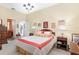 Spacious bedroom with coral bedding, a chandelier, and built-in shelving at 2210 Se Laurel Run Dr, Ocala, FL 34471