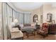 Elegant living room featuring comfortable seating and large windows at 2210 Se Laurel Run Dr, Ocala, FL 34471