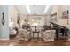 Spacious living room featuring hardwood floors, high ceilings, and a grand piano at 2210 Se Laurel Run Dr, Ocala, FL 34471