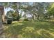 Spacious backyard with a fenced-in lawn and mature trees at 2210 Se Laurel Run Dr, Ocala, FL 34471