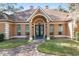 Inviting home exterior featuring a grand entrance and manicured lawn at 2210 Se Laurel Run Dr, Ocala, FL 34471