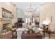 Spacious living area showcasing a piano, fireplace, and views into the dining room at 2210 Se Laurel Run Dr, Ocala, FL 34471