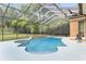 Relaxing freeform pool with a spa and a screened enclosure at 2210 Se Laurel Run Dr, Ocala, FL 34471