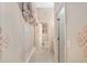 A long bathroom hallway with patterned wallpaper and access to multiple rooms at 2210 Se Laurel Run Dr, Ocala, FL 34471