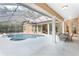 Spacious screened-in pool and patio area with a dining table at 2210 Se Laurel Run Dr, Ocala, FL 34471