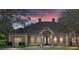 Tan two-story house with a double door entry and manicured lawn at 2210 Se Laurel Run Dr, Ocala, FL 34471