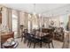 Spacious dining room with large windows, chandelier, and mirrored wall at 2210 Se Laurel Run Dr, Ocala, FL 34471