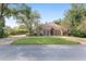 Tan two-story house with a double door entry and manicured lawn at 2210 Se Laurel Run Dr, Ocala, FL 34471