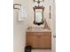 Small powder room with wood vanity, decorative mirror and nautical accents at 2210 Se Laurel Run Dr, Ocala, FL 34471