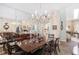 Elegant dining room featuring a large table, chandelier, and mirrored wall at 2210 Se Laurel Run Dr, Ocala, FL 34471