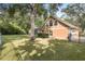 House exterior showcasing a large yard and mature trees at 2210 Se Laurel Run Dr, Ocala, FL 34471