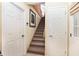 Image of a staircase with carpeted steps and neutral-colored walls at 2210 Se Laurel Run Dr, Ocala, FL 34471
