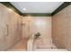 Walk-in shower with built-in bench, tiled walls, and grab bars at 4541 Ne 4Th St, Ocala, FL 34470