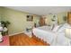 Bedroom with wood-look floors, white bedding, and green walls at 4541 Ne 4Th St, Ocala, FL 34470