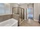 Bathroom with a large walk-in shower and soaking tub at 5584 Sw 43Rd Ct, Ocala, FL 34474