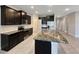 Modern kitchen with dark cabinets, granite counters and stainless steel appliances at 5584 Sw 43Rd Ct, Ocala, FL 34474