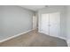 Simple bedroom with neutral walls and carpeted floor at 5584 Sw 43Rd Ct, Ocala, FL 34474