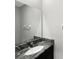 Bathroom with granite vanity and a large mirror at 5584 Sw 43Rd Ct, Ocala, FL 34474