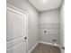 Laundry room with shelving and tile flooring at 5584 Sw 43Rd Ct, Ocala, FL 34474