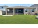 Home features a screened lanai, grassy backyard, and patio at 5584 Sw 43Rd Ct, Ocala, FL 34474