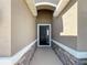 Elegant entryway with a dark door and stone accents at 5584 Sw 43Rd Ct, Ocala, FL 34474