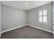 Simple bedroom with neutral walls, carpeted floor, and window with shutters at 5584 Sw 43Rd Ct, Ocala, FL 34474