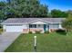 Front view of charming ranch house with a well-manicured lawn at 10783 Se 178Th St, Summerfield, FL 34491