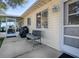 Concrete patio with bench, grill, and access to the house at 10783 Se 178Th St, Summerfield, FL 34491