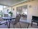 Screened lanai with outdoor furniture and view of dining area at 10783 Se 178Th St, Summerfield, FL 34491