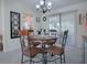 Elegant dining room with chandelier and four chairs at 10783 Se 178Th St, Summerfield, FL 34491