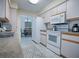 View of kitchen with white appliances and wood cabinets at 10783 Se 178Th St, Summerfield, FL 34491