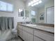 Clean bathroom with updated vanity and a large mirror at 10783 Se 178Th St, Summerfield, FL 34491