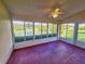 Sunroom with lake view and a ceiling fan at 5162 Harbour Dr, Oxford, FL 34484