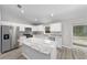 Kitchen island with granite countertop and stainless steel appliances at 8 Malauka Pass Pl, Ocklawaha, FL 32179