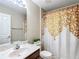 Clean bathroom with a shower and gold patterned curtain at 8335 Se 162Nd Pl, Summerfield, FL 34491