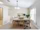 Elegant dining room with a chandelier and a spacious table for six at 8335 Se 162Nd Pl, Summerfield, FL 34491