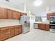 Modern kitchen with stainless steel appliances and wooden cabinetry at 8335 Se 162Nd Pl, Summerfield, FL 34491