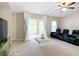 Relaxing living room with black leather recliners and sliding glass doors to the patio at 8335 Se 162Nd Pl, Summerfield, FL 34491