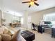 Open living space with a comfortable couch and a home office area at 8335 Se 162Nd Pl, Summerfield, FL 34491