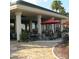 Community patio with tables, chairs, and umbrellas at 11703 Se 91St Cir, Summerfield, FL 34491