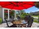 Outdoor patio with seating area, umbrella, and grill at 11703 Se 91St Cir, Summerfield, FL 34491