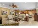 Open concept living room with kitchen views and a cozy seating area at 11703 Se 91St Cir, Summerfield, FL 34491