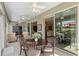 Sunroom with multiple seating areas and backyard view at 11703 Se 91St Cir, Summerfield, FL 34491