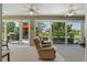 Sunroom with reclining chairs and view of backyard at 11703 Se 91St Cir, Summerfield, FL 34491