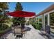 Brick patio with seating area and red umbrella at 11703 Se 91St Cir, Summerfield, FL 34491