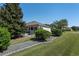 Landscaped backyard with mature trees and shrubs at 11703 Se 91St Cir, Summerfield, FL 34491