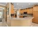 U-shaped kitchen with light wood cabinets and stainless steel appliances at 11703 Se 91St Cir, Summerfield, FL 34491