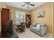 Home office with built-in shelving and comfortable seating at 11703 Se 91St Cir, Summerfield, FL 34491