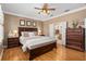 Main bedroom with king bed, dresser, and ensuite bathroom access at 11703 Se 91St Cir, Summerfield, FL 34491